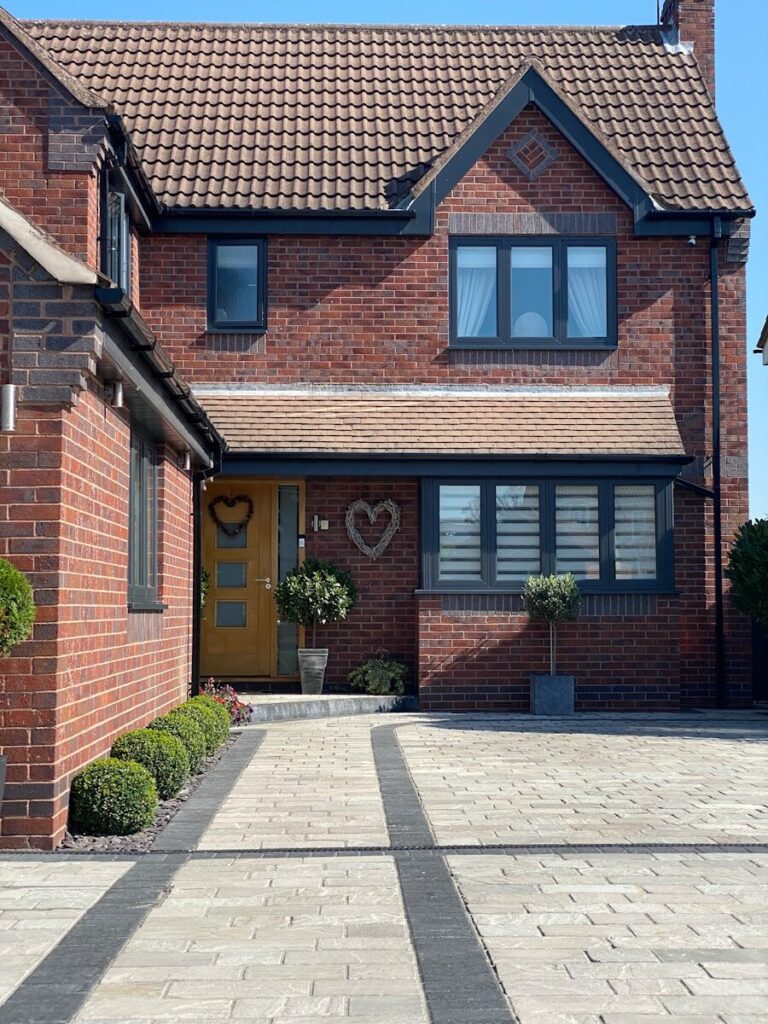 a large brick house with a yellow door