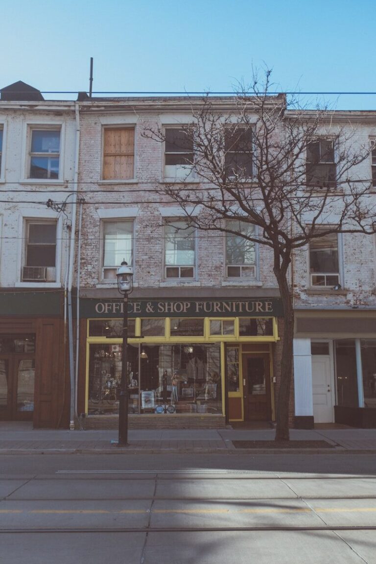 an old building with a tree in front of it